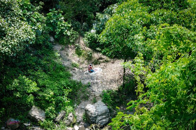 Praying alone at the foot of the hills, Khoiyachhara waterfall
